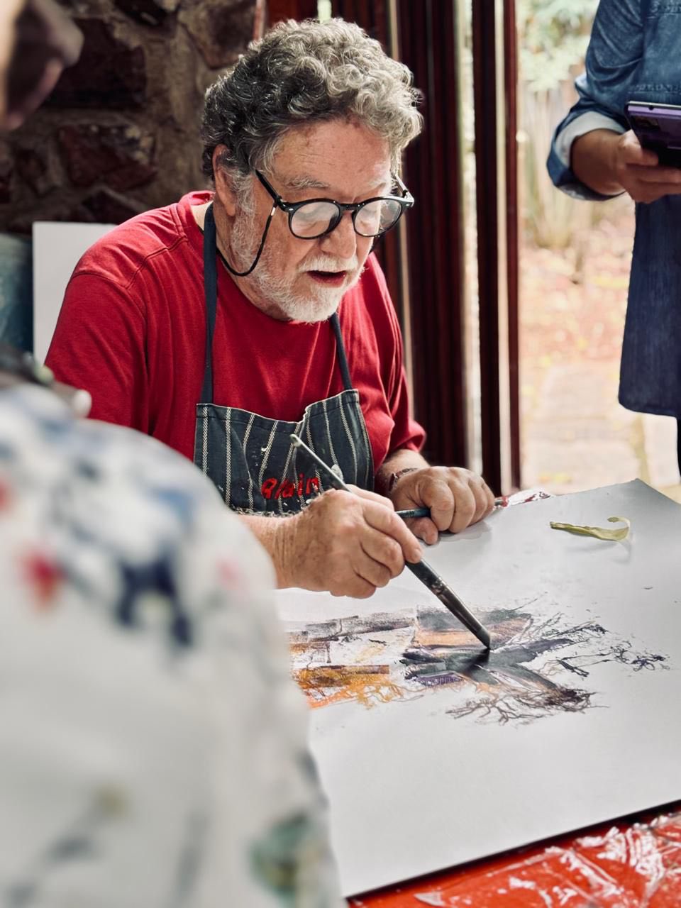 Alain carefully crafting a custom frame in his studio